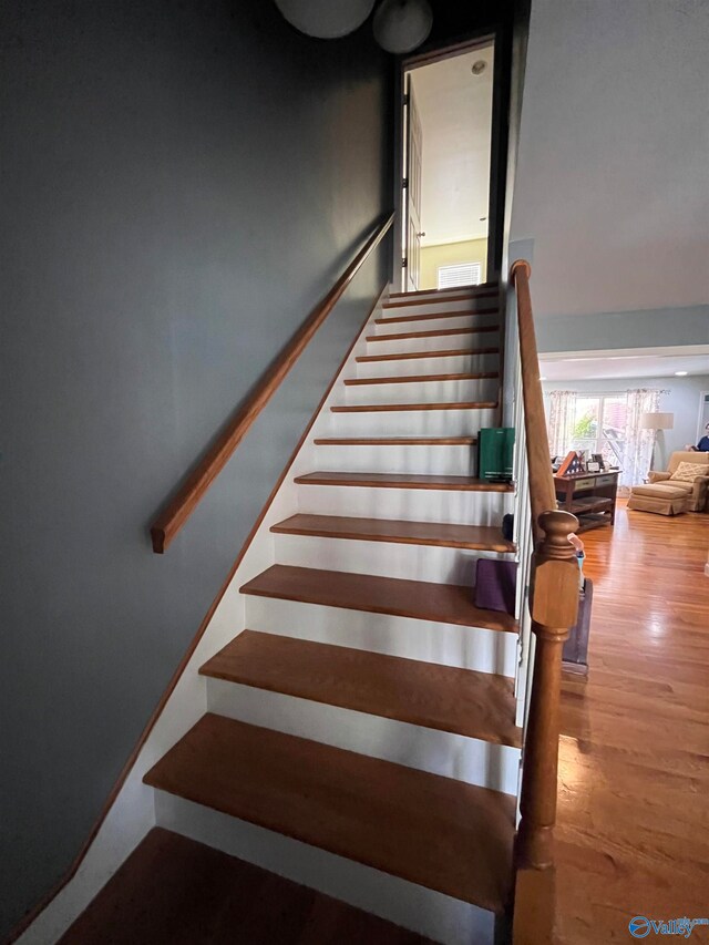 stairway with wood-type flooring