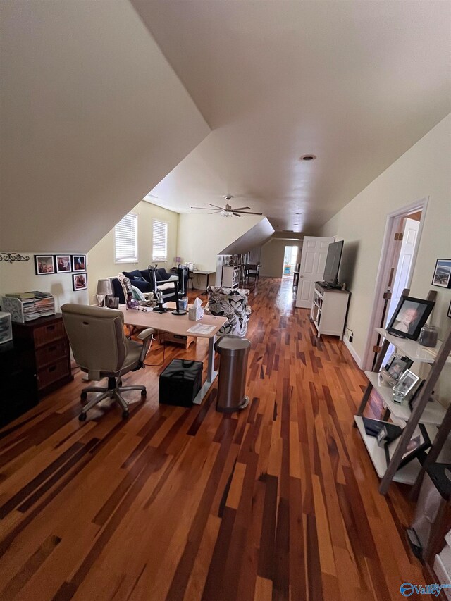 home office featuring lofted ceiling, dark wood-type flooring, and ceiling fan