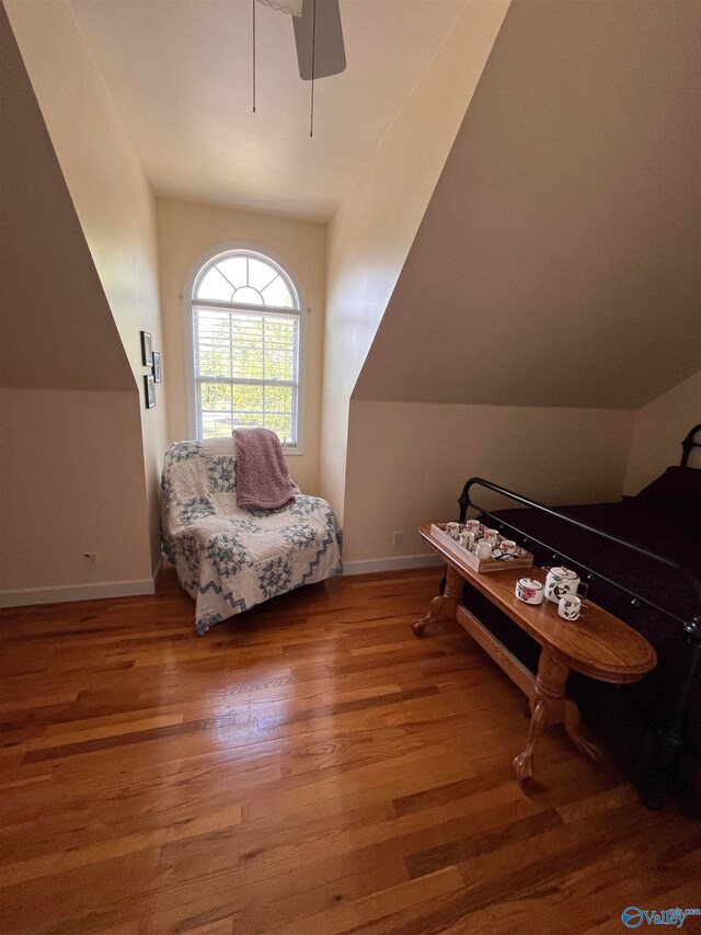 interior space featuring ceiling fan, hardwood / wood-style flooring, and vaulted ceiling