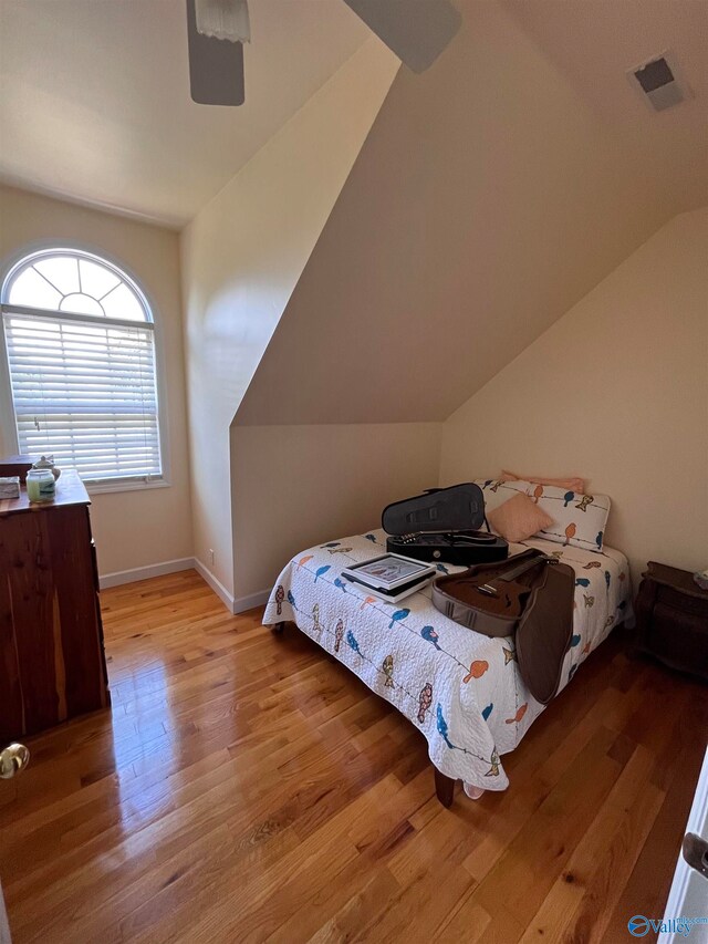 bedroom featuring light wood-type flooring and lofted ceiling