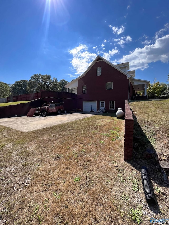 view of side of property with a garage and a yard