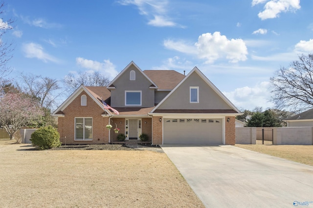 traditional home with a front lawn, a gate, fence, concrete driveway, and brick siding