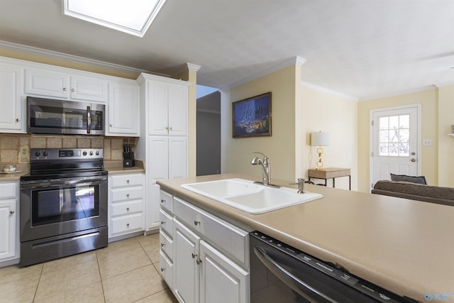 kitchen with white cabinetry, tasteful backsplash, appliances with stainless steel finishes, and a sink