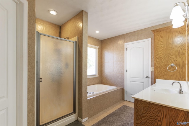 full bathroom featuring a shower stall, a garden tub, recessed lighting, tile patterned floors, and vanity