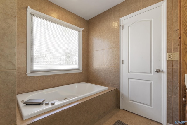 full bath featuring tile patterned floors, a garden tub, and tile walls