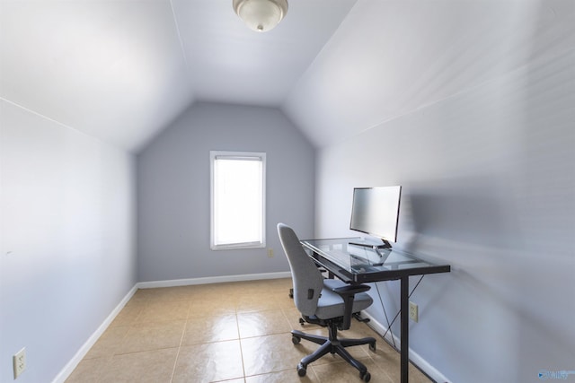 tiled office space with vaulted ceiling and baseboards