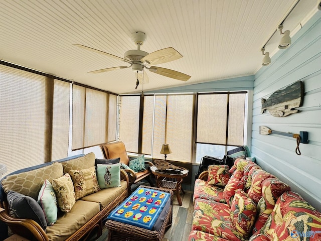 sunroom with a ceiling fan, track lighting, outdoor lounge area, and wood finished floors