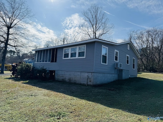 view of side of property featuring a lawn and cooling unit