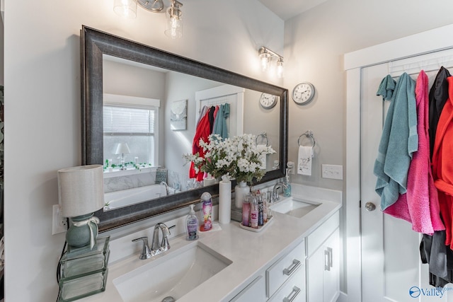 bathroom with vanity and a bath