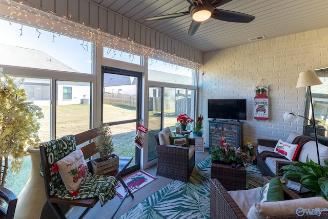 sunroom with wood ceiling, plenty of natural light, and ceiling fan