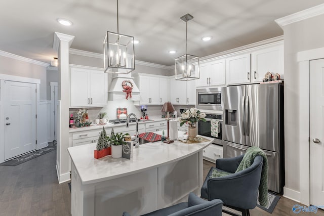 kitchen featuring appliances with stainless steel finishes, dark hardwood / wood-style flooring, decorative light fixtures, and white cabinetry