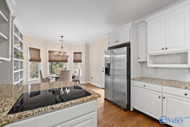 kitchen with black electric stovetop, wood finished floors, white cabinetry, open shelves, and stainless steel fridge