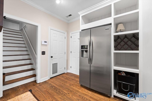 kitchen featuring wood finished floors, visible vents, ornamental molding, stainless steel fridge with ice dispenser, and open shelves