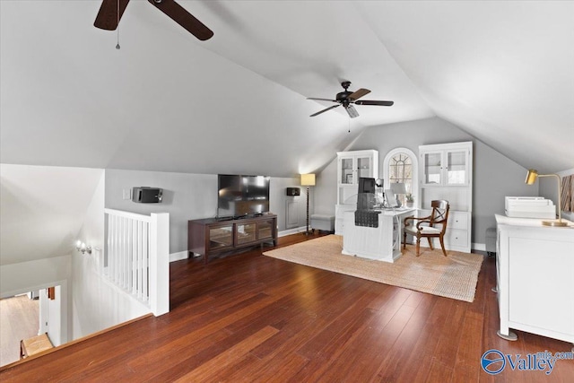 bedroom with lofted ceiling, hardwood / wood-style floors, and baseboards