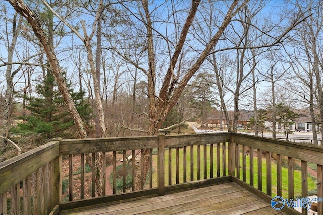 wooden terrace featuring a lawn