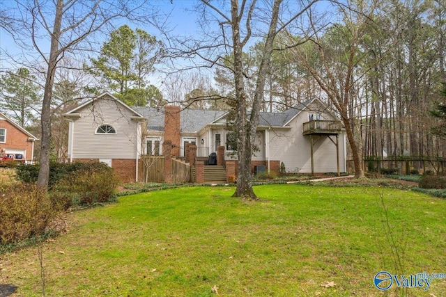 exterior space featuring brick siding, a chimney, and a front lawn