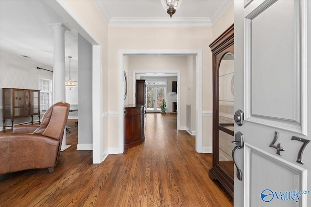 hallway with ornamental molding, dark wood-type flooring, and baseboards