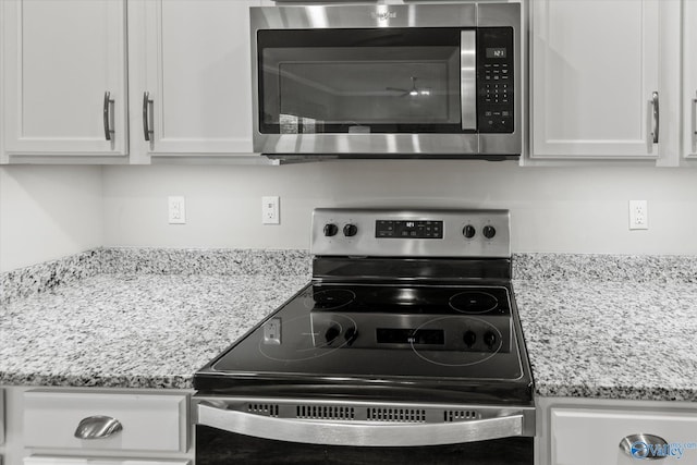 14930 Eva Cir, Athens, AL 35613 - kitchen featuring appliances with stainless steel finishes, white cabinets, and light stone countertops