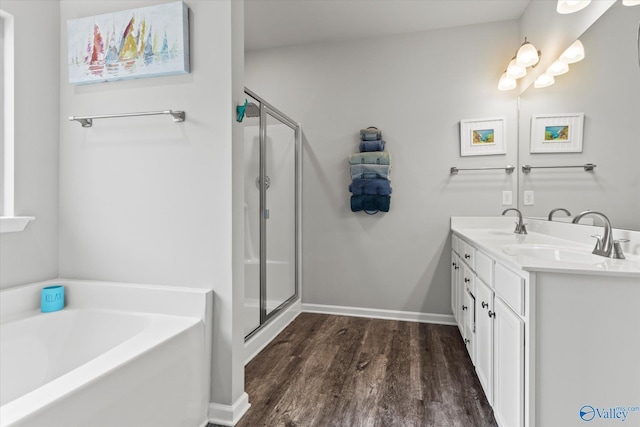 14930 Eva Cir, Athens, AL 35613 - full bath featuring wood finished floors, a garden tub, a stall shower, and double vanity