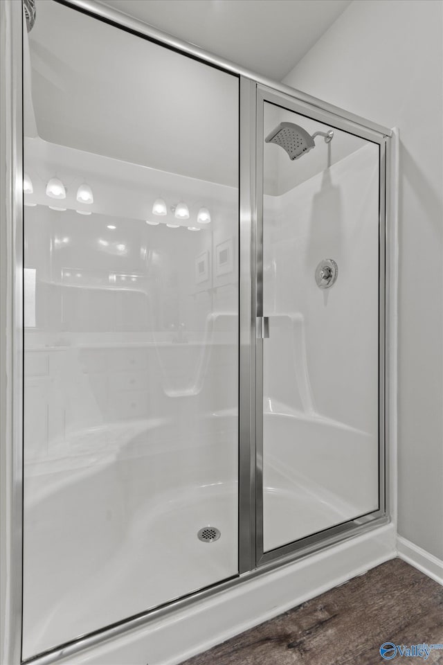 14930 Eva Cir, Athens, AL 35613 - bathroom featuring a shower stall and wood finished floors