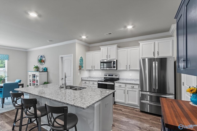14930 Eva Cir, Athens, AL 35613 - kitchen with stainless steel appliances, dark wood-style flooring, ornamental molding, light stone countertops, and white cabinets