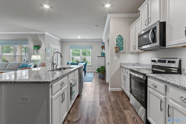 14930 Eva Cir, Athens, AL 35613 - kitchen featuring stainless steel appliances, dark wood-style flooring, white cabinetry, a center island with sink, and crown molding