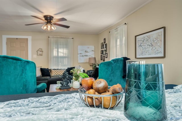 living room featuring ceiling fan and crown molding