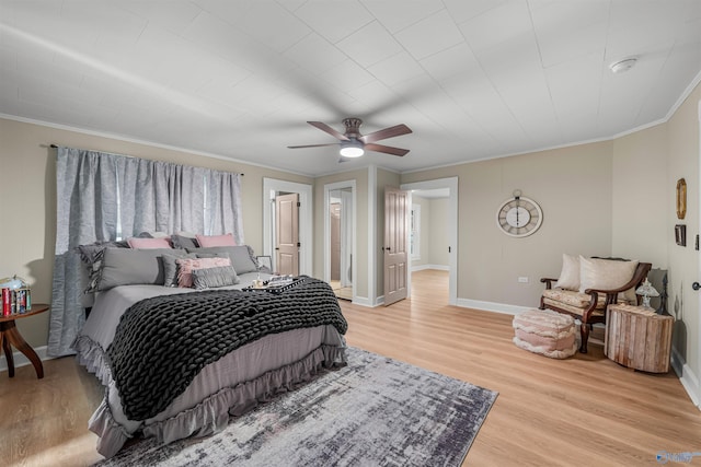 bedroom featuring light wood-type flooring, ceiling fan, and crown molding