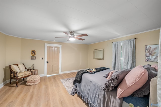 bedroom with light wood-type flooring, ceiling fan, and ornamental molding