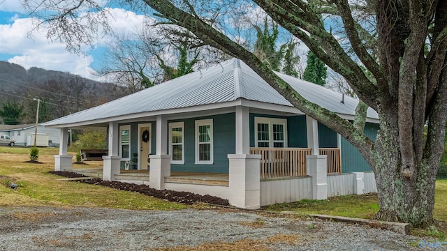 view of property exterior with covered porch and a yard