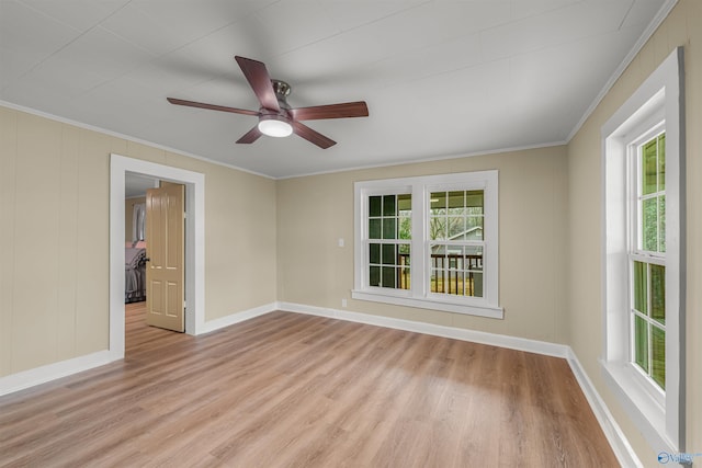 spare room featuring plenty of natural light, light hardwood / wood-style floors, and ornamental molding