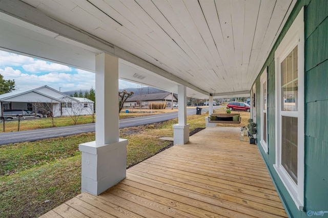 wooden terrace featuring covered porch