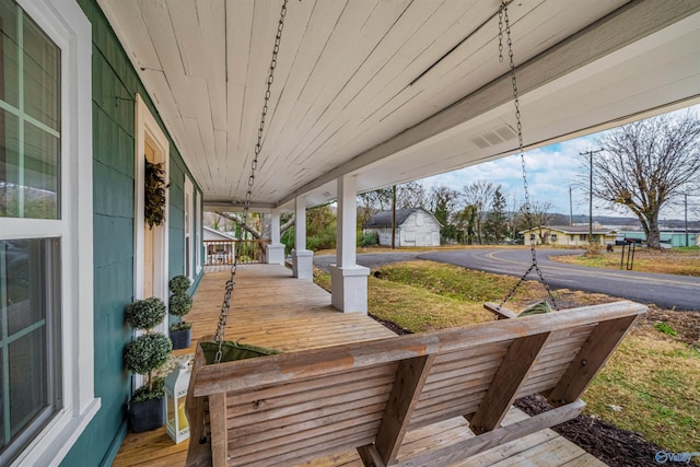 wooden deck featuring covered porch