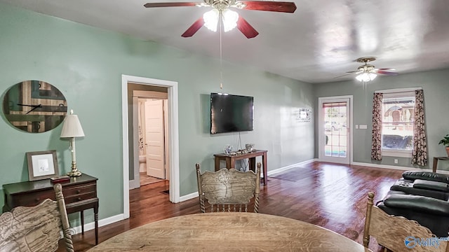 living room with ceiling fan and dark hardwood / wood-style flooring