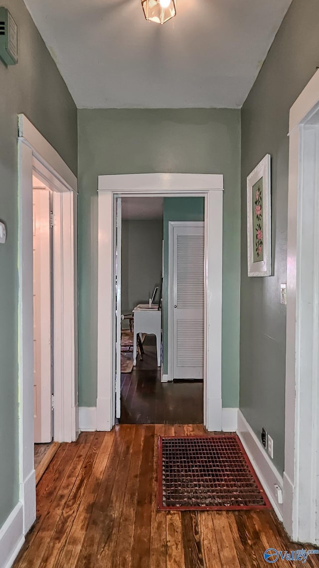 hallway featuring dark hardwood / wood-style flooring