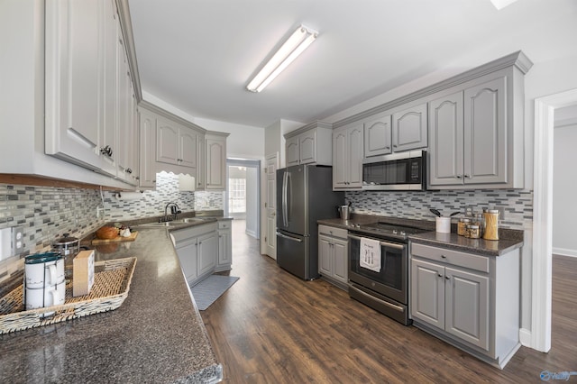 kitchen featuring gray cabinetry, stainless steel appliances, and dark hardwood / wood-style floors