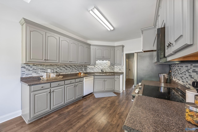 kitchen featuring decorative backsplash, black stove, white dishwasher, gray cabinets, and dark hardwood / wood-style flooring