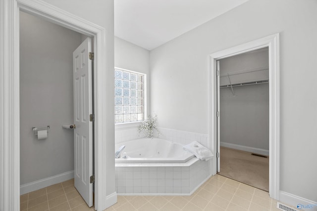 bathroom featuring tiled bath