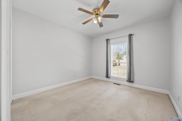 carpeted spare room featuring ceiling fan