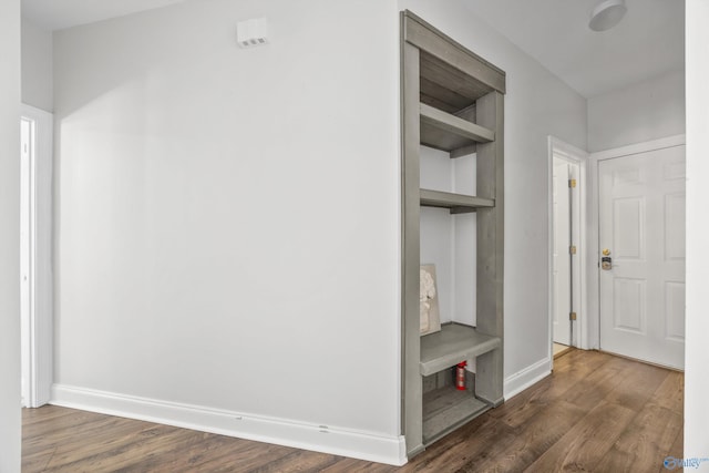 hallway with dark hardwood / wood-style flooring