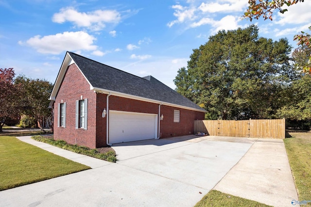 view of home's exterior featuring a yard and a garage