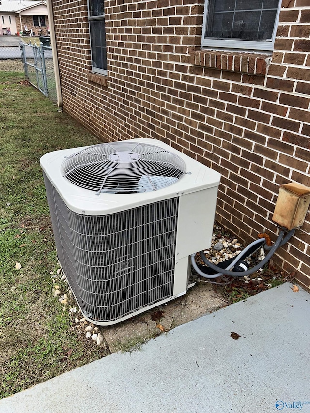 393 Canadian Dr, Scottsboro, AL 35769 - details with cooling unit, brick siding, and fence