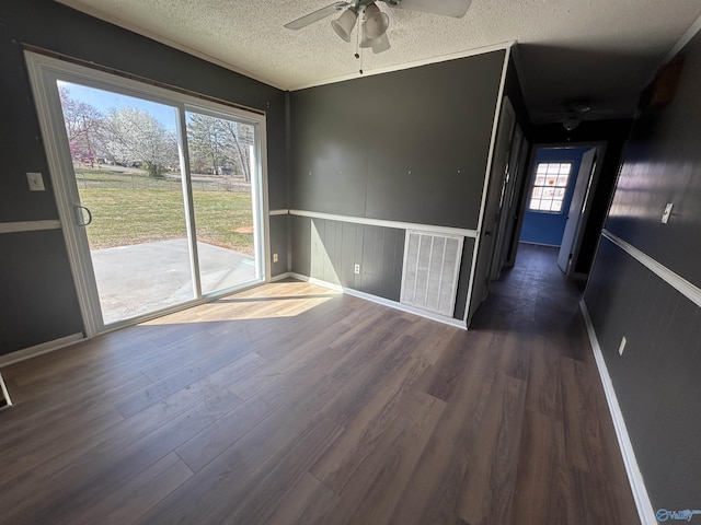 393 Canadian Dr, Scottsboro, AL 35769 - unfurnished dining area with a textured ceiling, visible vents, wood finished floors, and a ceiling fan