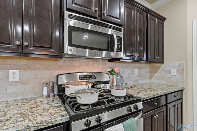 kitchen featuring decorative backsplash, dark brown cabinets, and stainless steel appliances