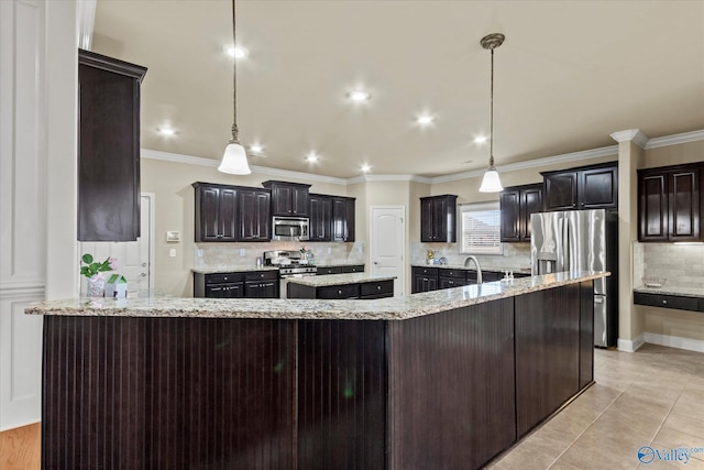 kitchen with a large island, stainless steel appliances, tasteful backsplash, decorative light fixtures, and light tile patterned flooring