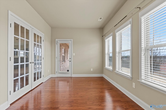 spare room with french doors and wood-type flooring