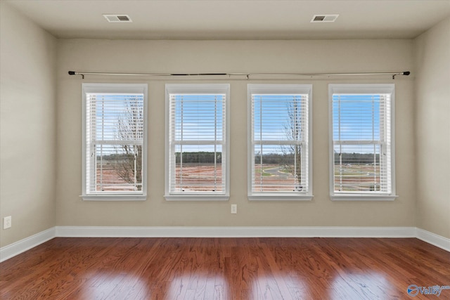 empty room with hardwood / wood-style floors