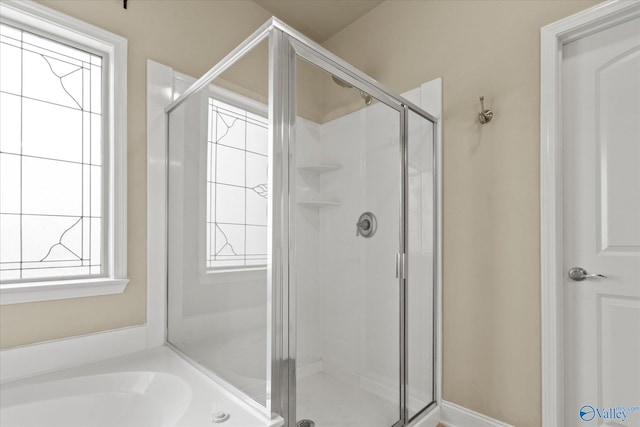 bathroom featuring shower with separate bathtub