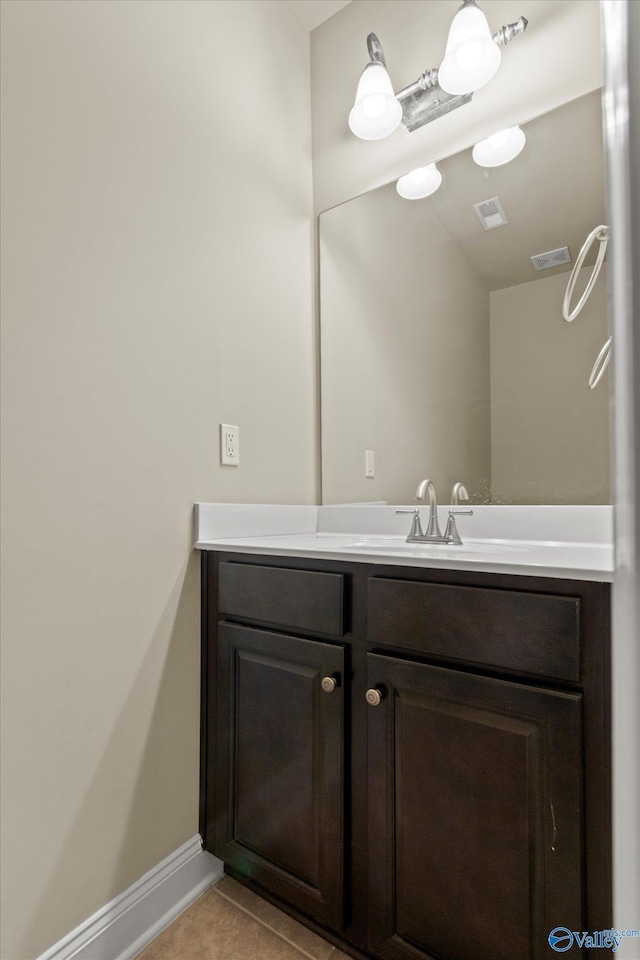 bathroom with tile patterned flooring and vanity