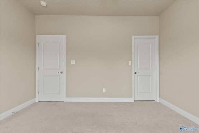 empty room with light colored carpet